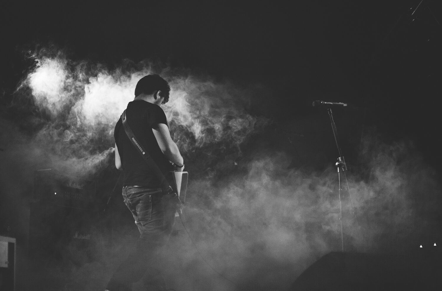 Guitarist performing on stage in smoke
