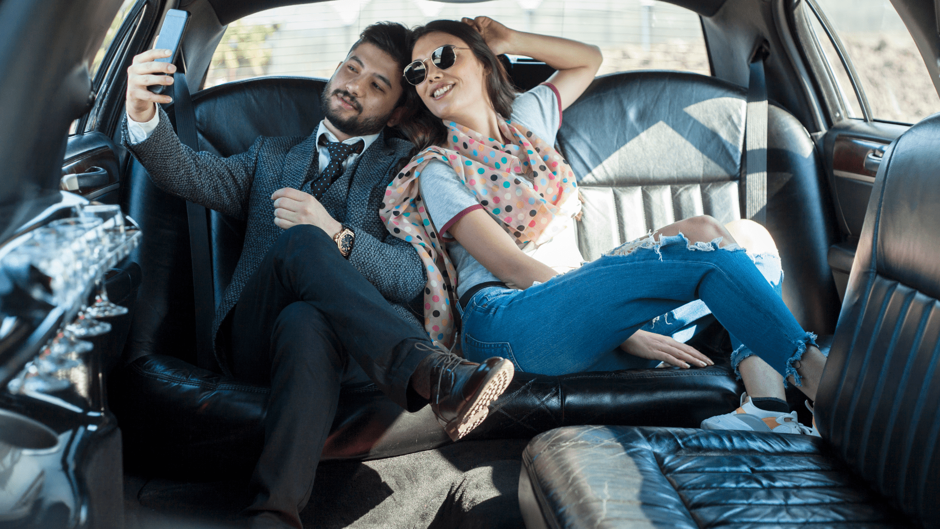 Couple taking selfie in luxury car