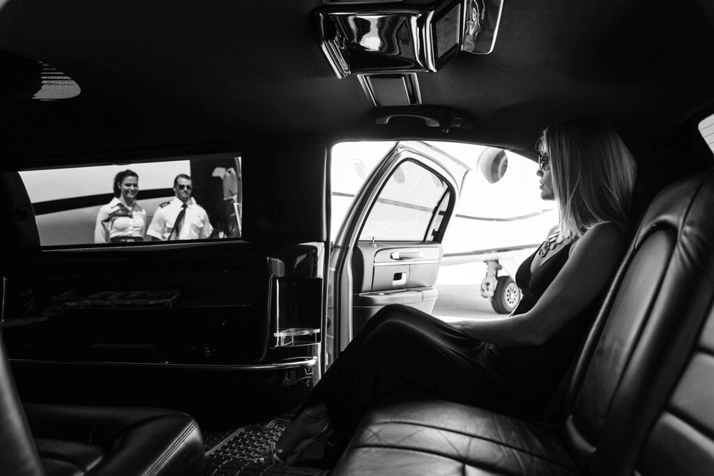 Woman sitting in luxurious limousine interior