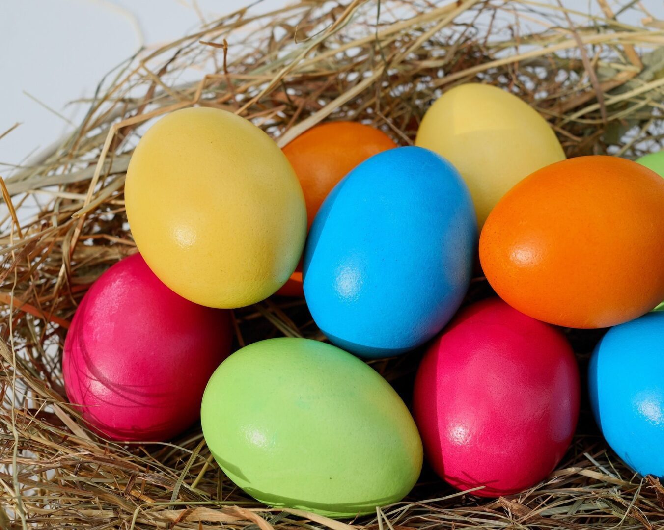 Multicolored eggs resting in hay
