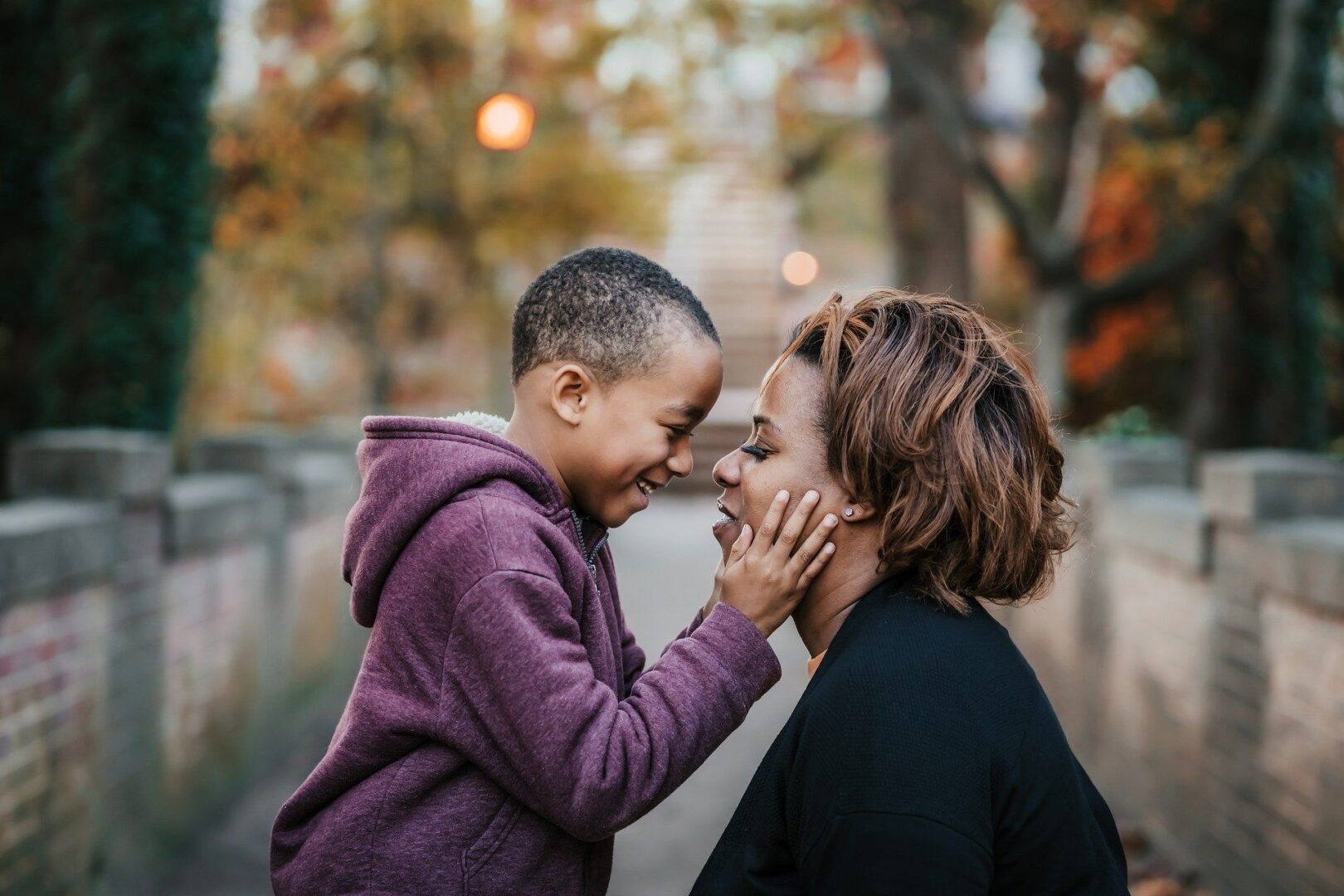 Smiling child touching mother's face lovingly