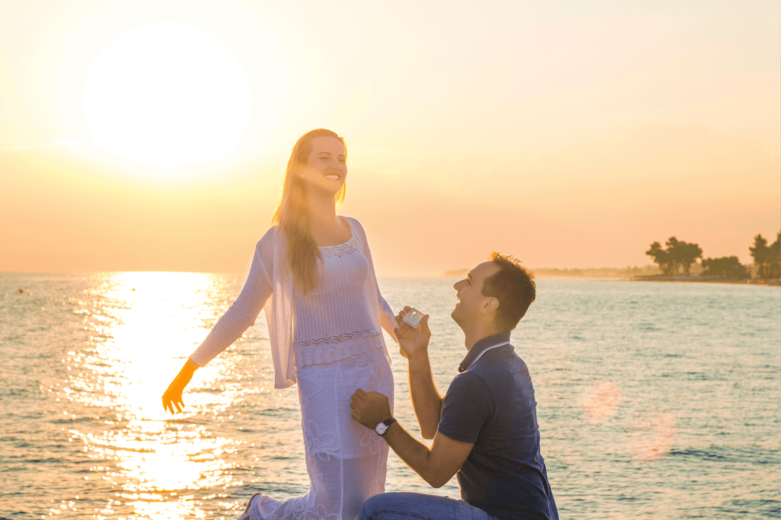 Romantic beachside proposal at sunset