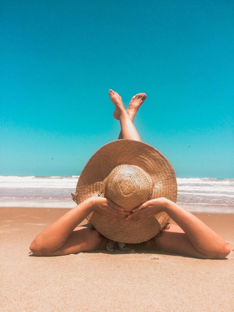 Person relaxing on sandy beach