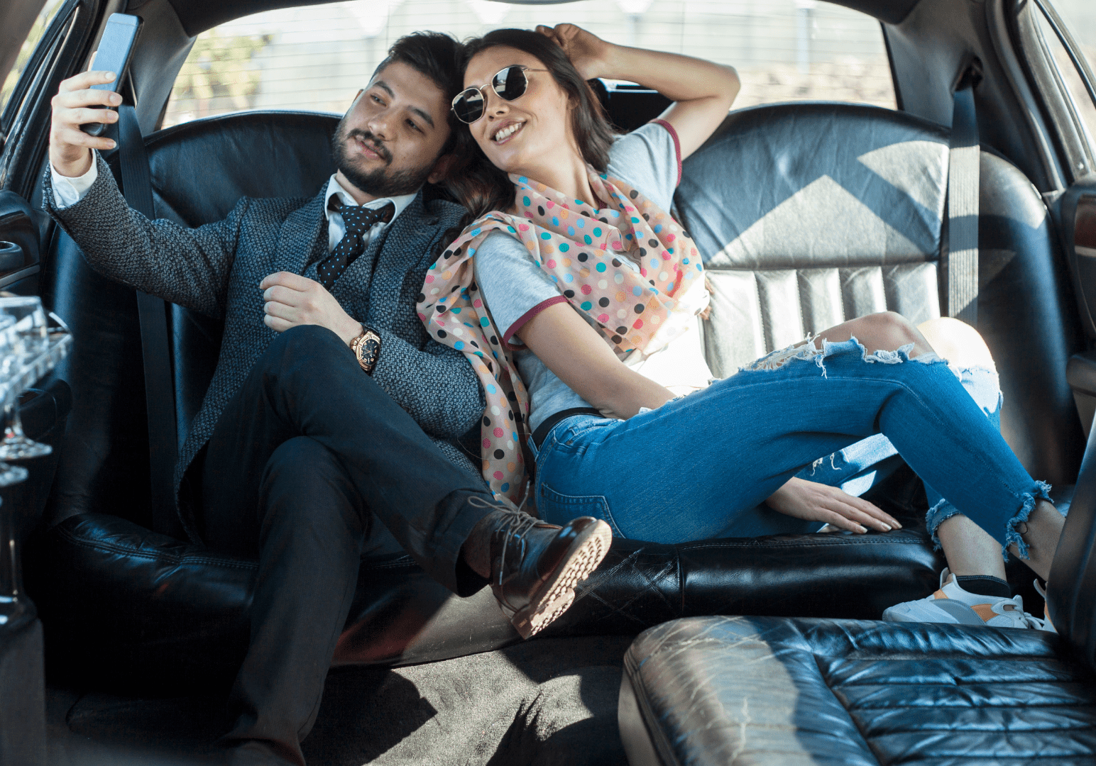 Couple taking selfie in luxury car