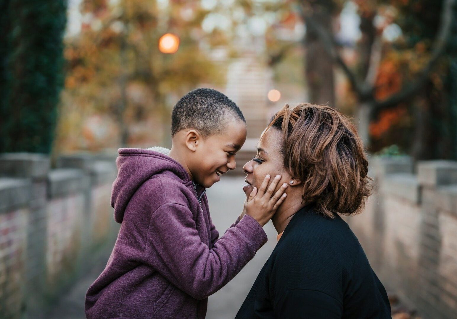 Smiling child touching mother's face lovingly