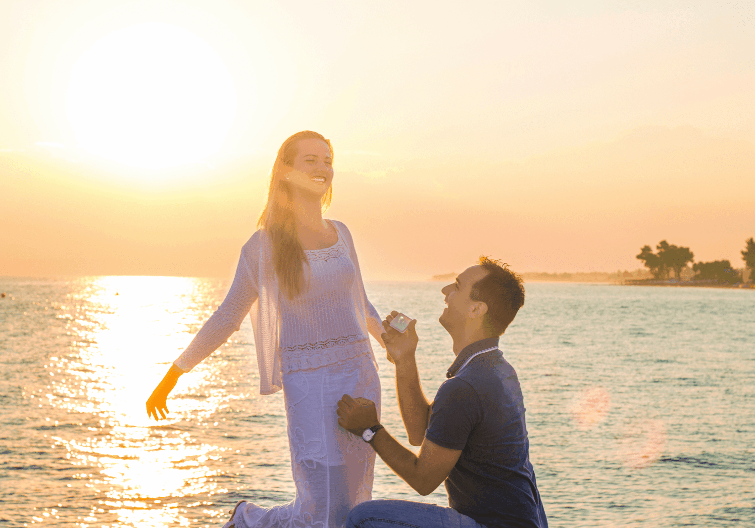 Romantic beachside proposal at sunset