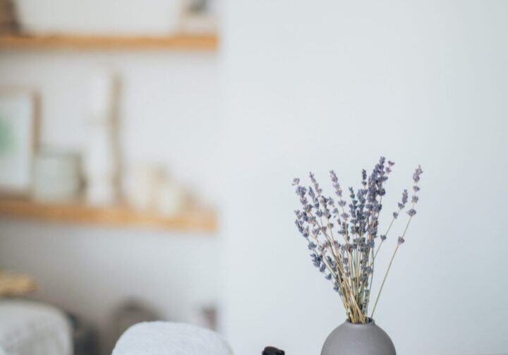 Cozy spa decor with lavender vase.
