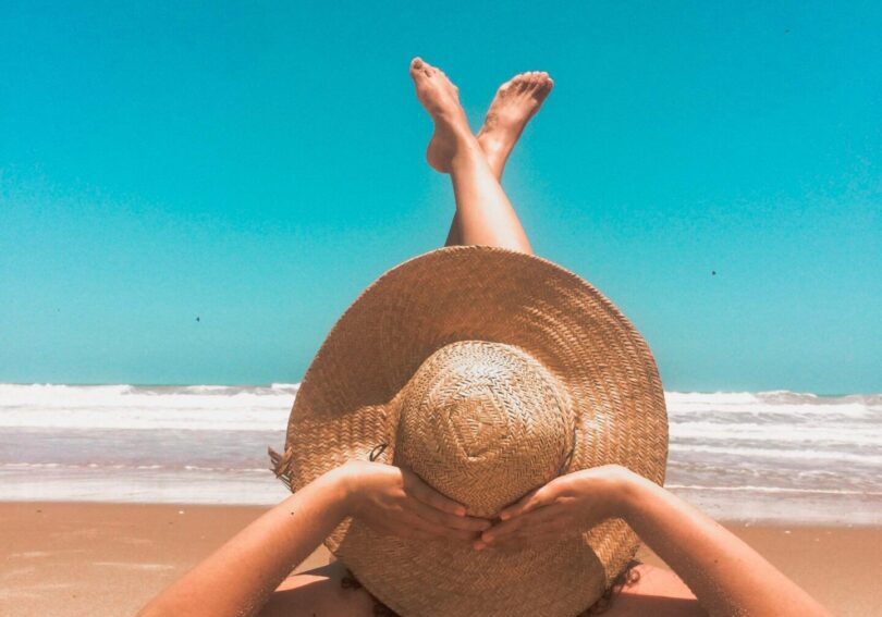 Person relaxing on sandy beach