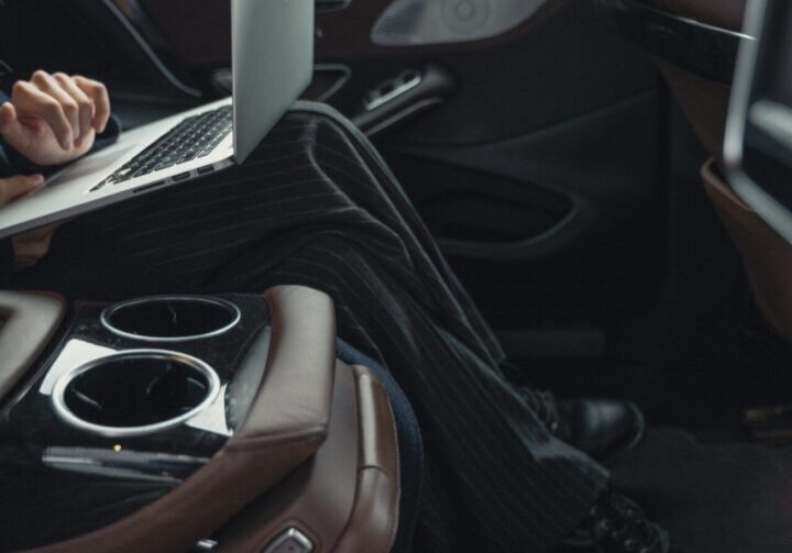 Person working on laptop in car