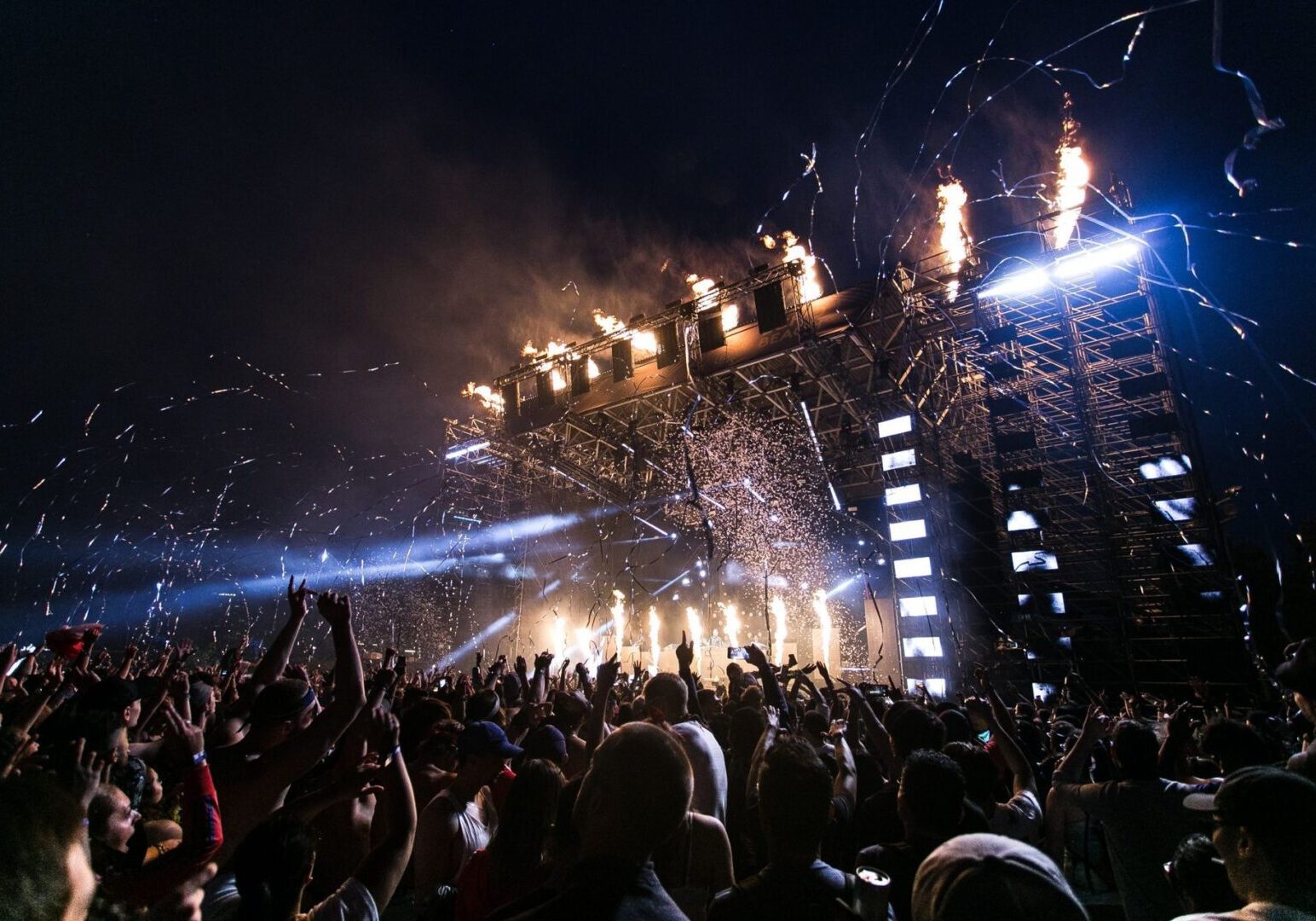 Concert crowd enjoying fireworks and lights