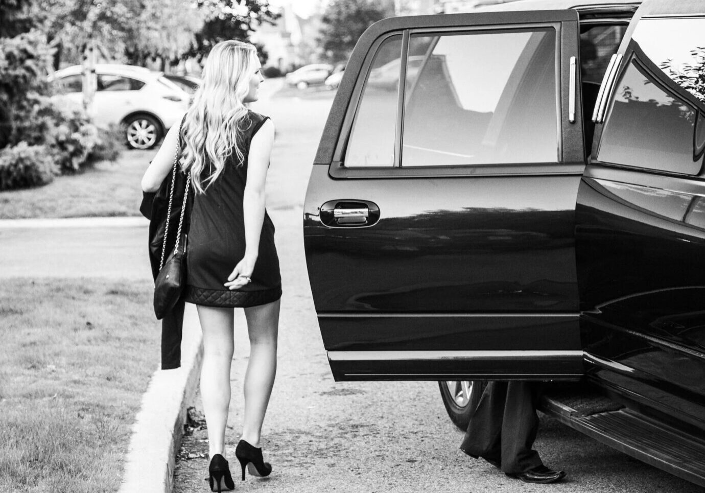 Elegant woman near open car door